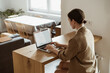 © Palina Liashkovich/Stocksy - Stay home, blog, social media concept. Woman working at home.