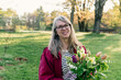 © Léa Jones/Stocksy - beautiful middled aged woman holding a flower arrangement