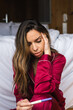 © David Prado/Stocksy - Sad woman with pregnancy test