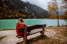 Anonymous Female Looking At The Lake In Autumn Season