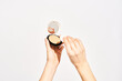 © Martí Sans/Stocksy - Woman applying compact cosmetic powder