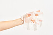 © Martí Sans/Stocksy - Woman with cosmetic sheet mask on hand