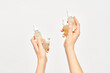 © Martí Sans/Stocksy - Set of bottles with cosmetic oil in hands of woman