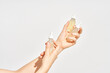 © Martí Sans/Stocksy - Bottles of cosmetic serum in hands of woman