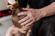 © Kelsey Smith/Stocksy - Young boy having his hair cut at home with dad