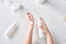 Female Hands With Cleansing Foam Bottle.
