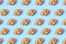 Pattern Of Croissants With Peonies On Blue Background