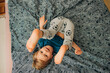 © Olga Moreira/Stocksy - Boy having fun on bed