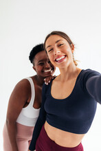 Two Sportswomen Taking Selfie Photo In Studio 