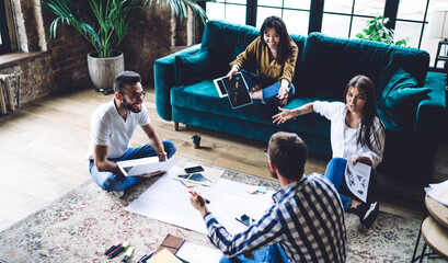 Sticker - Ethnic woman demonstrating black picture to coworkers during meeting