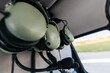 © Marcos Osorio/Stocksy - Headphones hanging from the ceiling of a helicopter