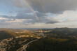 © Marcos Osorio/Stocksy - View of rainbow from inside a helicopter through the window