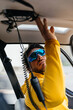 © Marcos Osorio/Stocksy - Helicopter pilot with sunglasses preparing to fly