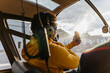 © Marcos Osorio/Stocksy - Helicopter pilot checking his cell phone before flying