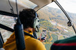 © Marcos Osorio/Stocksy - Helicopter passenger taking photos with his mobile