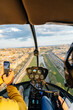© Marcos Osorio/Stocksy - Helicopter passenger taking photos with his mobile