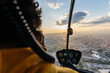 © Marcos Osorio/Stocksy - Helicopter passenger taking photos with his mobile