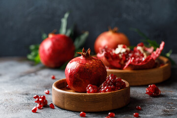 Wall Mural - Ripe juicy pomegranate on grey background. Food background