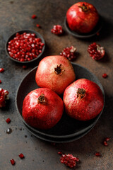 Wall Mural - Ripe juicy pomegranate on grey background. Food background