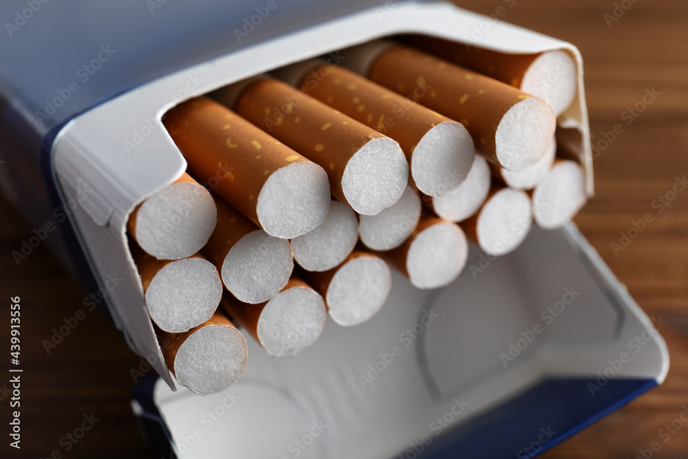 Pack of cigarettes on wooden table, closeup Stock Photo
