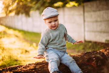 Cute and handsome baby boy 1-2 years old exploring nature in summer, having fun