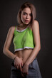 © Denis Ivanov - Gorgeous sexy blonde girl in a crop top and jeans poses on a dark background