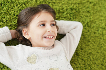 Wall Mural - Portrait of beautiful teen girl lying on floor in room