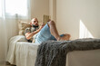 © Eloisa Ramos/Stocksy - modern man relaxing with his tablet at home