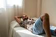© Eloisa Ramos/Stocksy - modern man lying on the bed