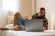 © Eloisa Ramos/Stocksy - Modern man using his laptop at home