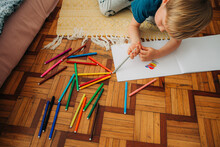 Kid Drawing While Sitting On The Floor