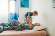 © Olga Moreira/Stocksy - Mother and her son playing in bed