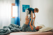 © Olga Moreira/Stocksy - Mother and her son playing in bed