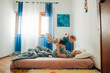 © Olga Moreira/Stocksy - Mother and her son playing in bed