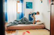 © Olga Moreira/Stocksy - Mother holding her son while lying down in bed