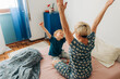 © Olga Moreira/Stocksy - Mother and son stratching in bed in the morning