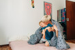 © Olga Moreira/Stocksy - Mother and her 5 years old boy having fun in bed