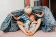© Olga Moreira/Stocksy - Mom and her 5 years old son playing in bed