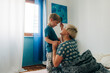 © Olga Moreira/Stocksy - Mother brushing her son while sitting in bed