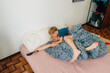 © Olga Moreira/Stocksy - Mother and 5 years old son having fun in bed in the morning
