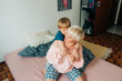 © Olga Moreira/Stocksy - 5 years old boy hugging his mom in bed
