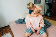 © Olga Moreira/Stocksy - 5 years old boy hugging his mom in bed