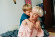 © Olga Moreira/Stocksy - 5 years old boy hugging his mom in bed