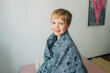 © Olga Moreira/Stocksy - 5 years old boy wrapped in blanket
