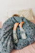 © Olga Moreira/Stocksy - Kid lying down in bed, wrapped in blanket