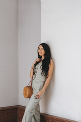 Wall Mural - portrait of a beautiful young woman 29 years old with dark long hair on a summer day.