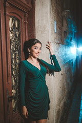 Canvas Print - Vertical shot of a white Caucasian woman wearing a green evening dress and posing for a picture