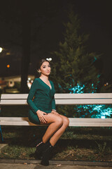 Wall Mural - Vertical shot of a white Caucasian woman wearing a green evening dress and posing for a picture