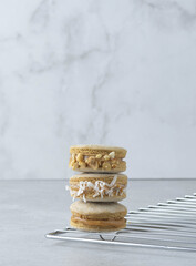 Sticker - Vertical shot of delicious macarons of various fillings stacked on a grid