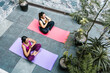 © Marcos - Mexican women sitting doing yoga in the morning on the terrace in latin america